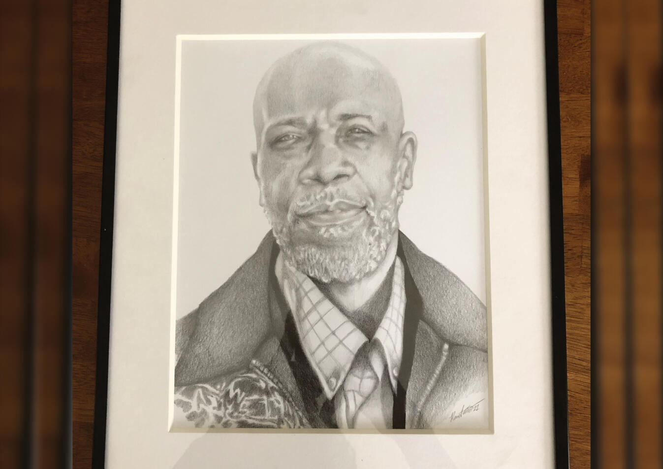 A framed pencil portrait (permission granted to display)